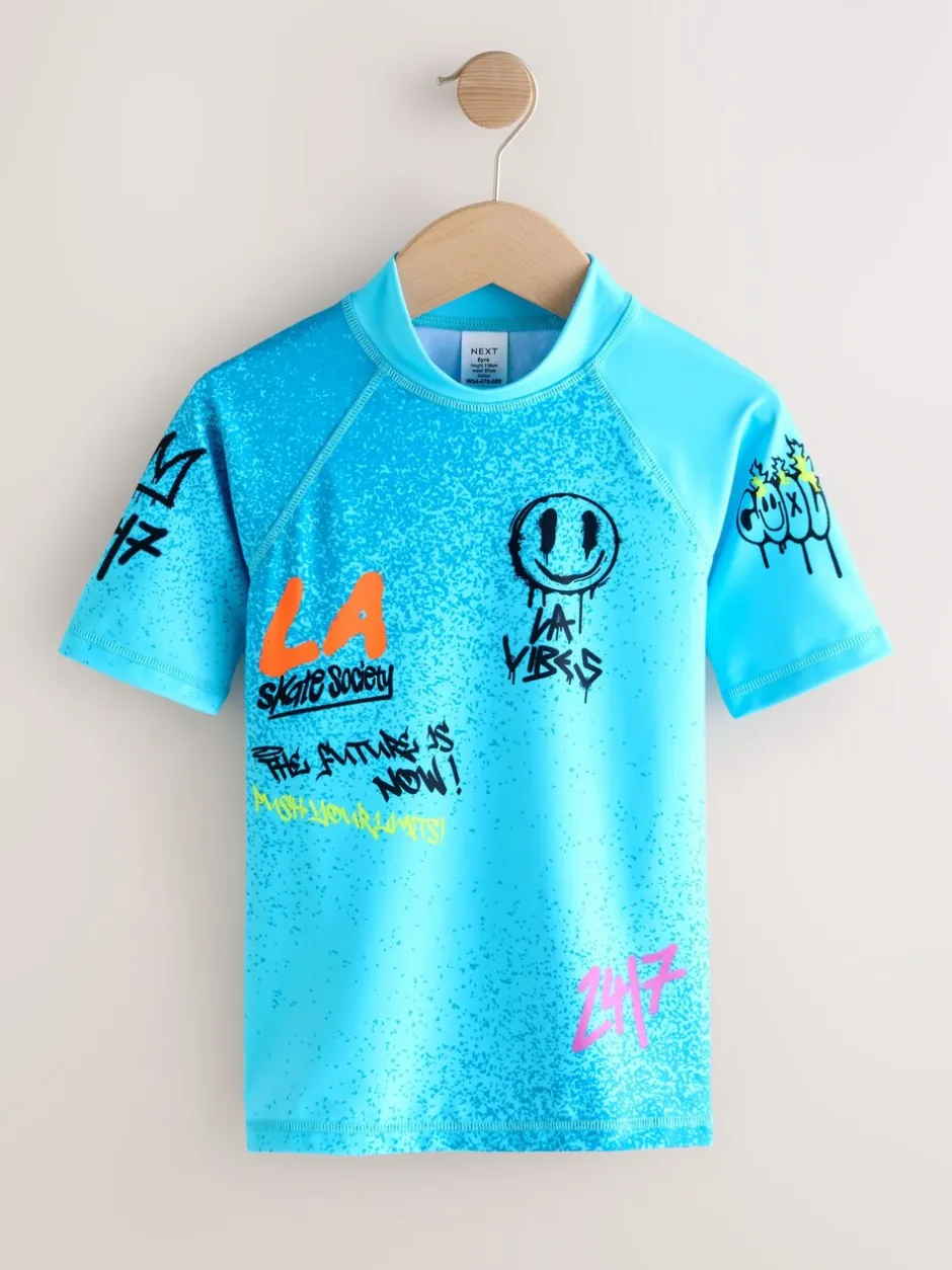Badkleding*Next Blauw met graffitiprint - Surfhemdje (1,5 - 16 jr)