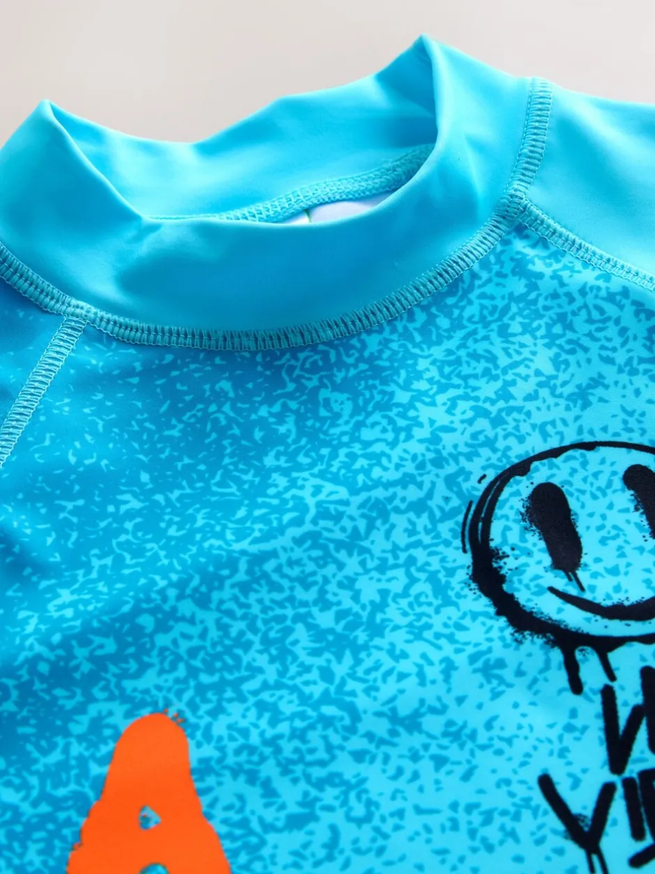 Badkleding*Next Blauw met graffitiprint - Surfhemdje (1,5 - 16 jr)