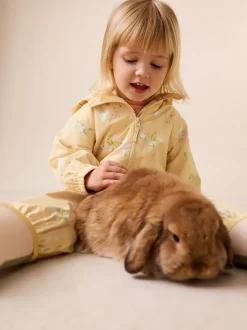 Jassen, Jacks En Kinderwagenpakjes|Jassen En Jacks|Next - Waterbestendig regenpak met print (6 mnd-7 jr) Citroengeel