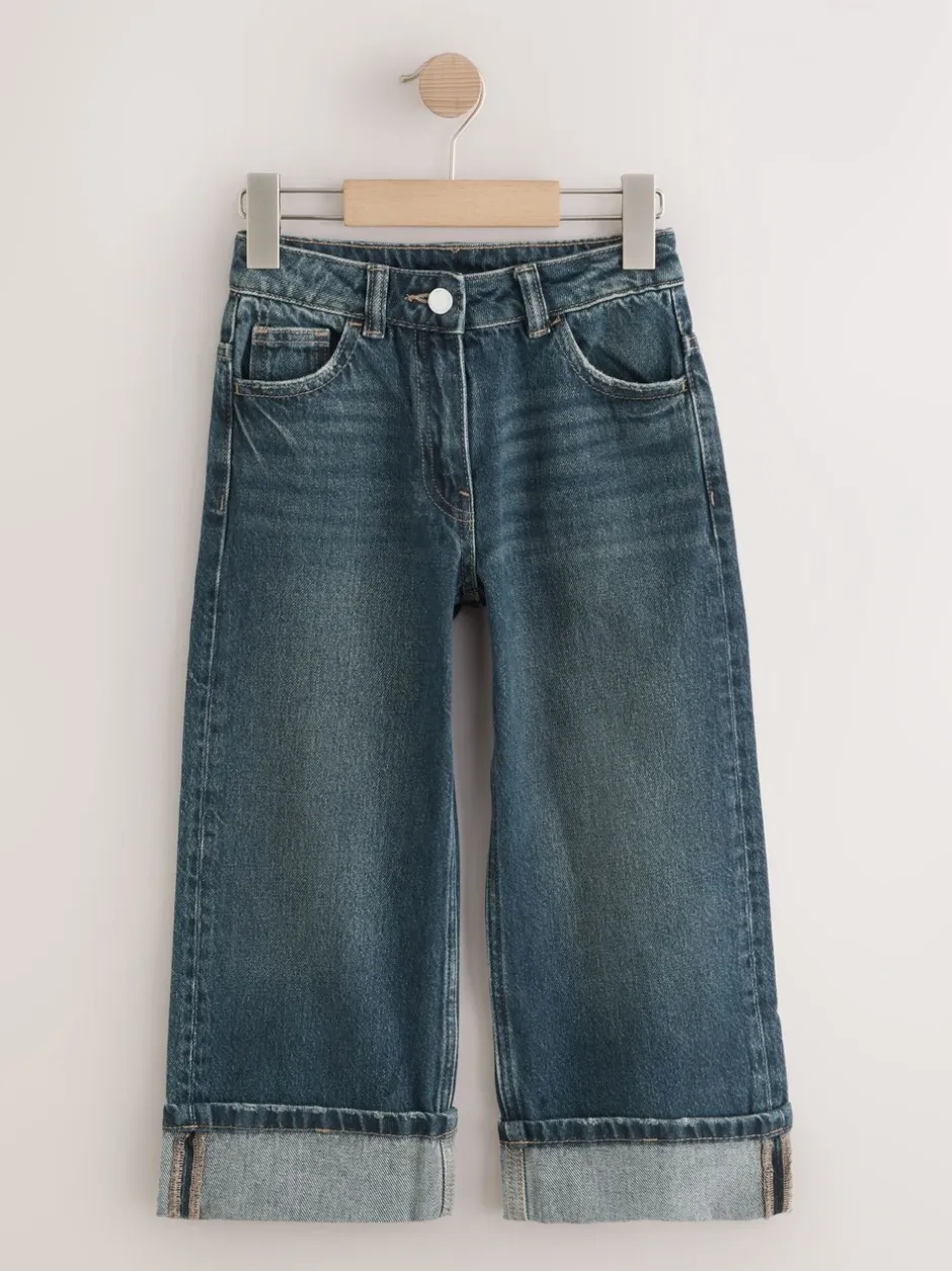 Jeans*Next Donkerblauw - Jeans met omgeslagen wijde pijpen (3-16jr)