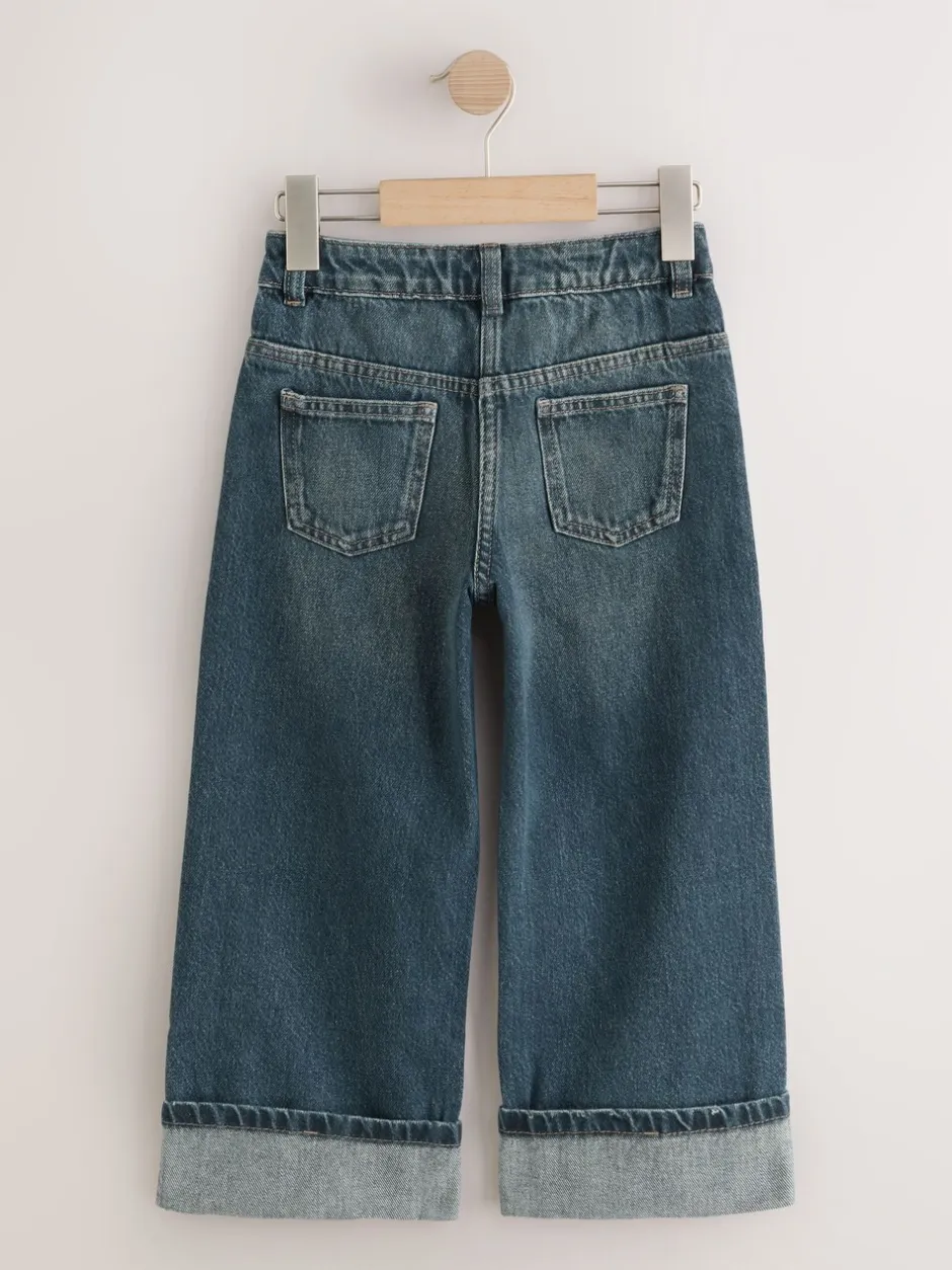 Jeans*Next Donkerblauw - Jeans met omgeslagen wijde pijpen (3-16jr)