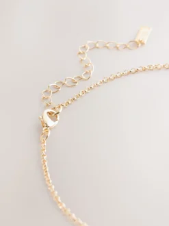 Sieraden|Next - Ketting met hangertje van vereende ringen Goudkleurig