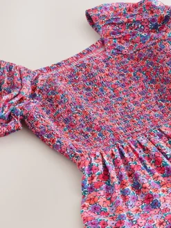 Jumpsuits En Playsuits*Next Roze met vrolijke print - Romper met smokwerk (3-16jr)
