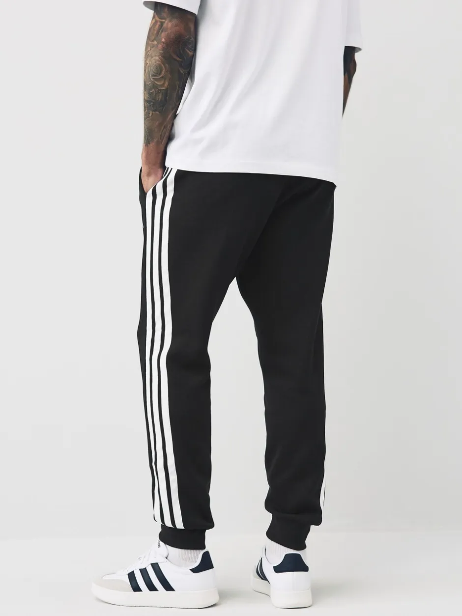 Joggingbroeken*adidas - Essentials fleece joggingbroek met 3 strepen Zwart