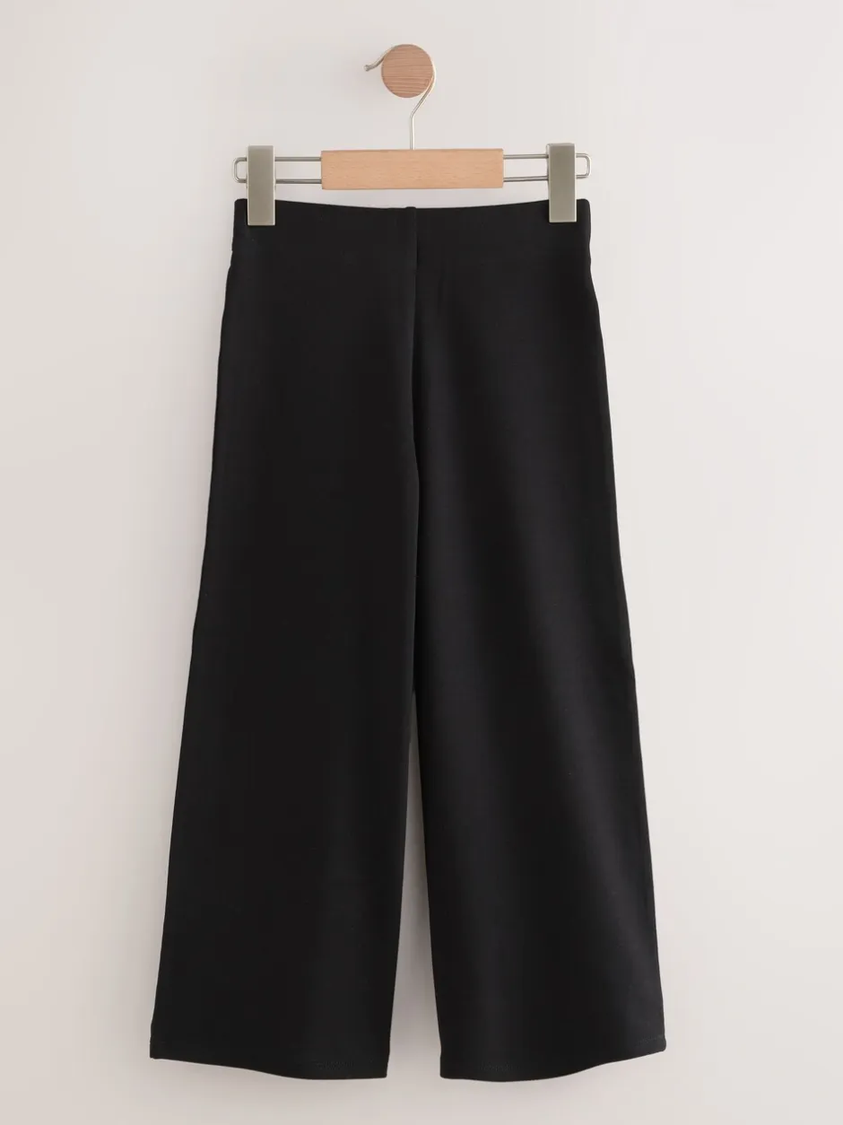 Schoolkleding|Next - Jersey broek met wijde pijpen, stretch en hoog katoengehalte (3-17jr) Zwart