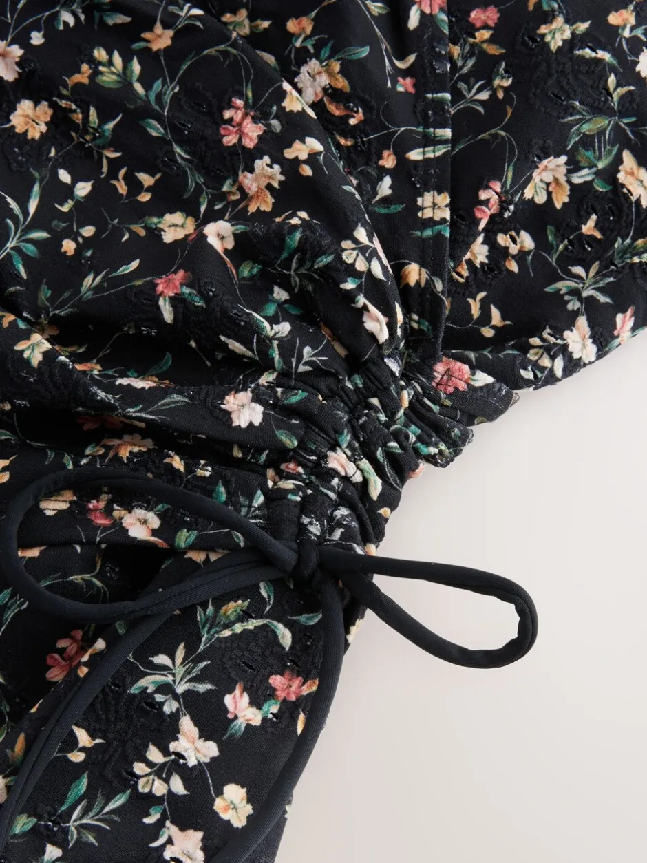 Badkleding|Next Zwart met broderie en fijne print - Badpak met vormgevende zijrimpeling en buikcorrectie