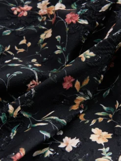 Badkleding|Next Zwart met broderie en fijne print - Badpak met vormgevende zijrimpeling en buikcorrectie
