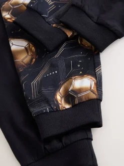 Pyjama's*Next Zwart met goudkleurige voetbal - Verpakking van 2 pyjama's met lange mouwen (3-16 jr)